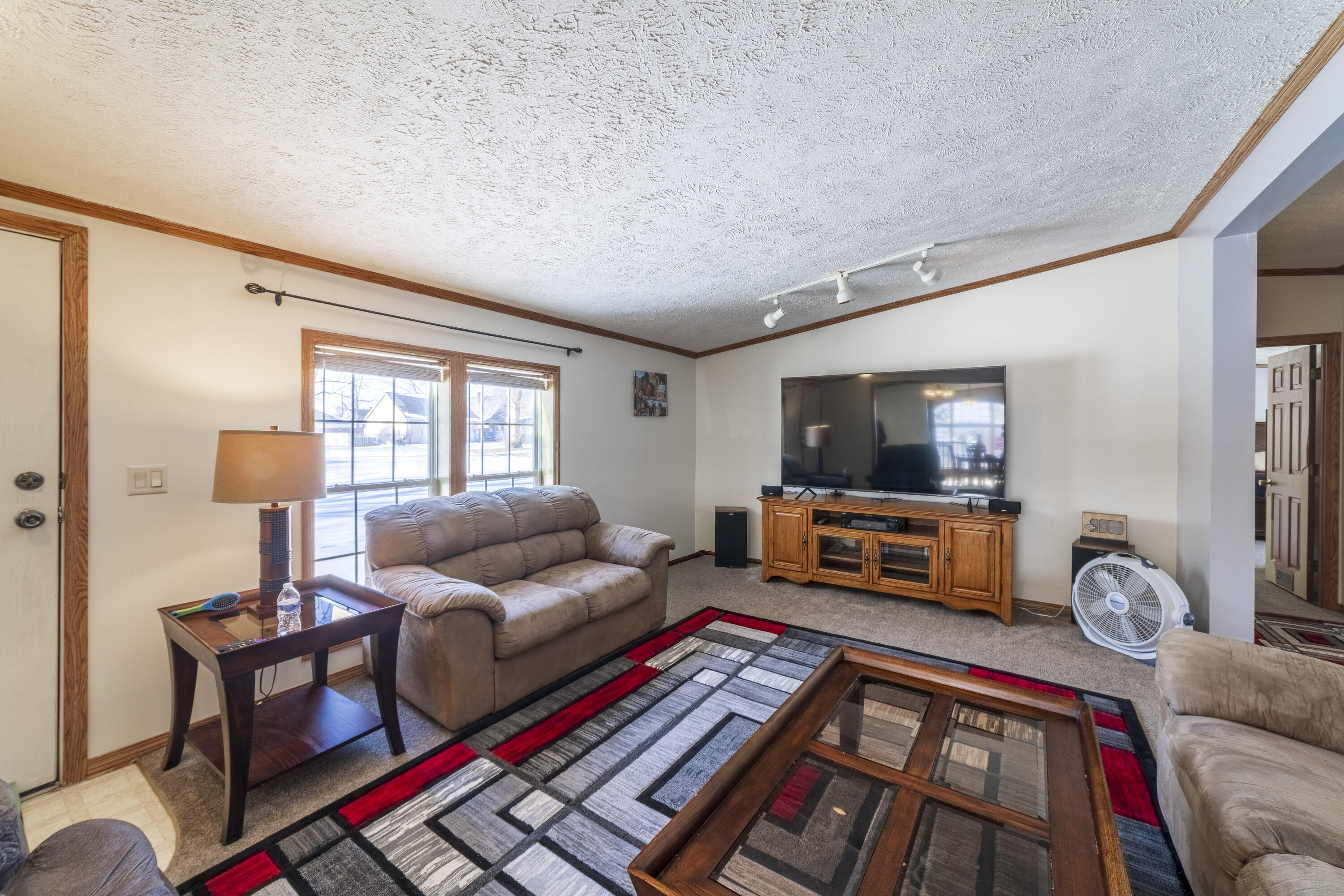 409 South Street Hebron, IN 46341 - Photo 20 of 36 a living room with furniture and a flat screen tv