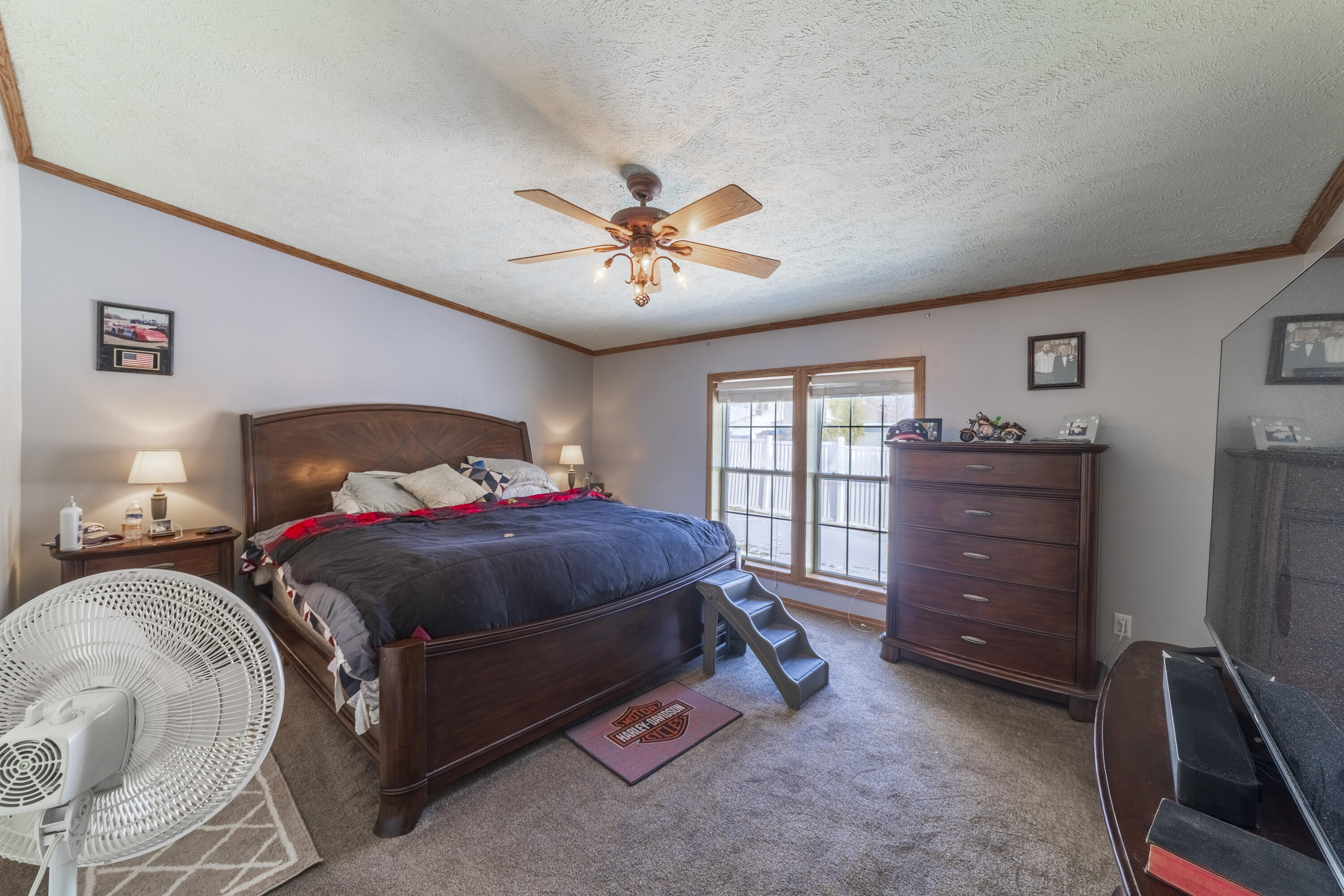 409 South Street Hebron, IN 46341 - Photo 23 of 36 a bedroom with a bed and a chandelier