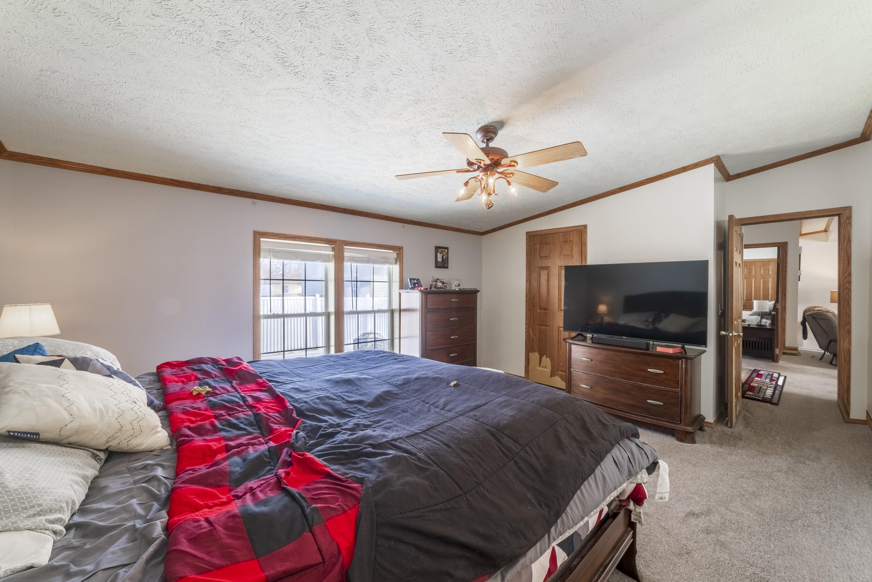 409 South Street Hebron, IN 46341 - Photo 24 of 36 a bedroom with a bed and a flat screen tv