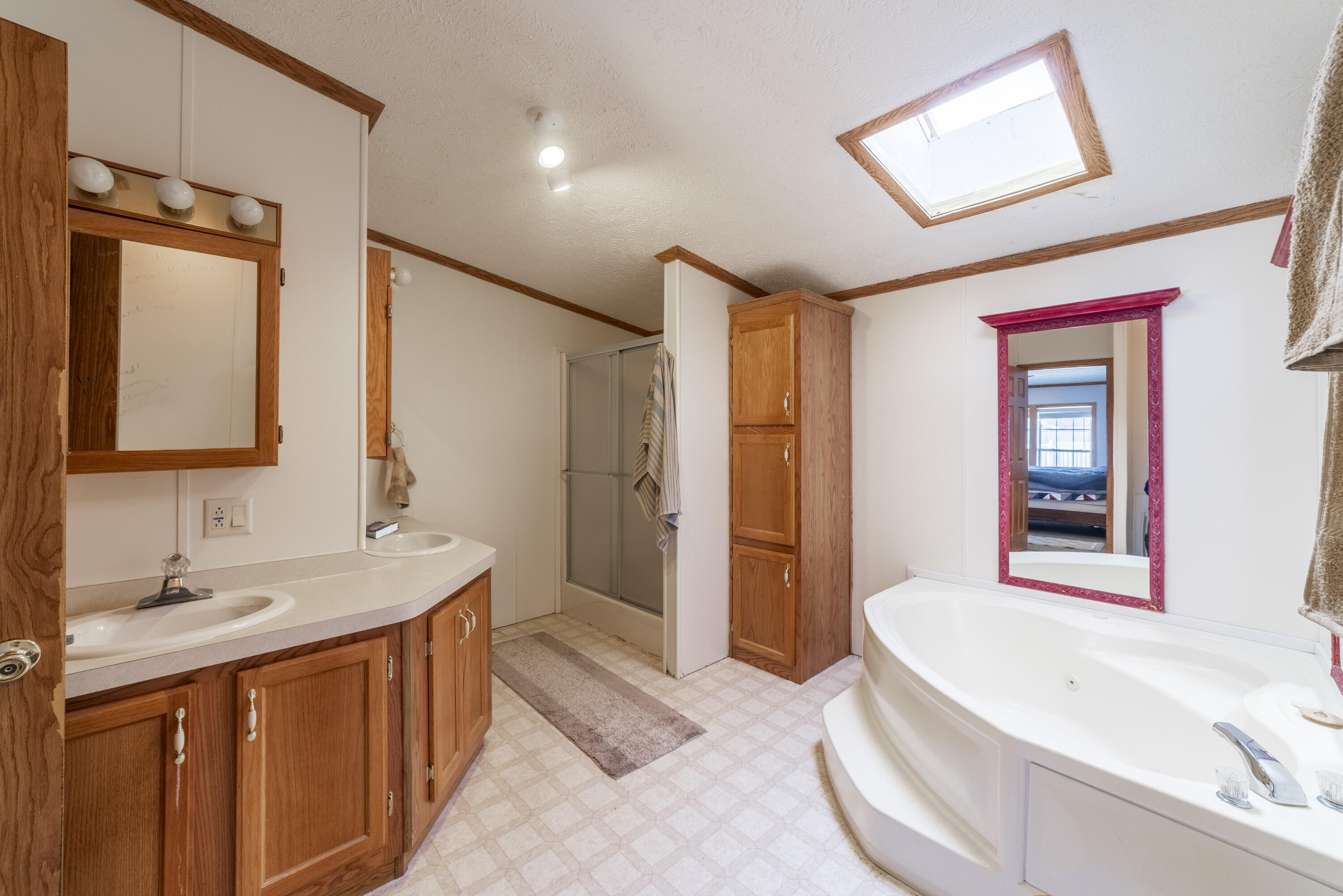 409 South Street Hebron, IN 46341 - Photo 26 of 36 a spacious bathroom with a tub sink and mirror