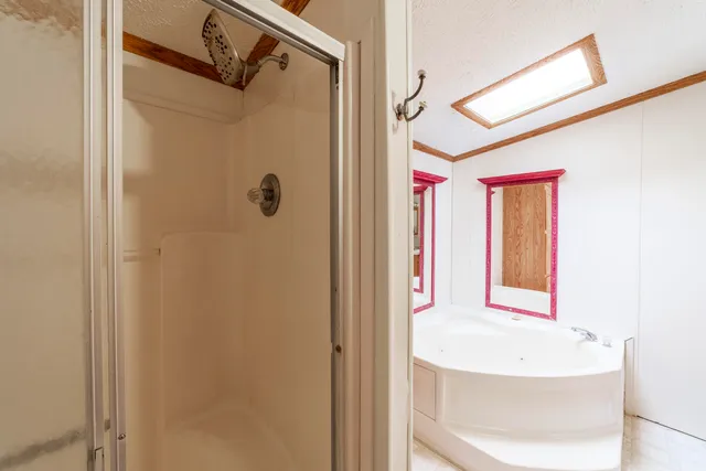 a bedroom with a bed and a dresser with wooden floor