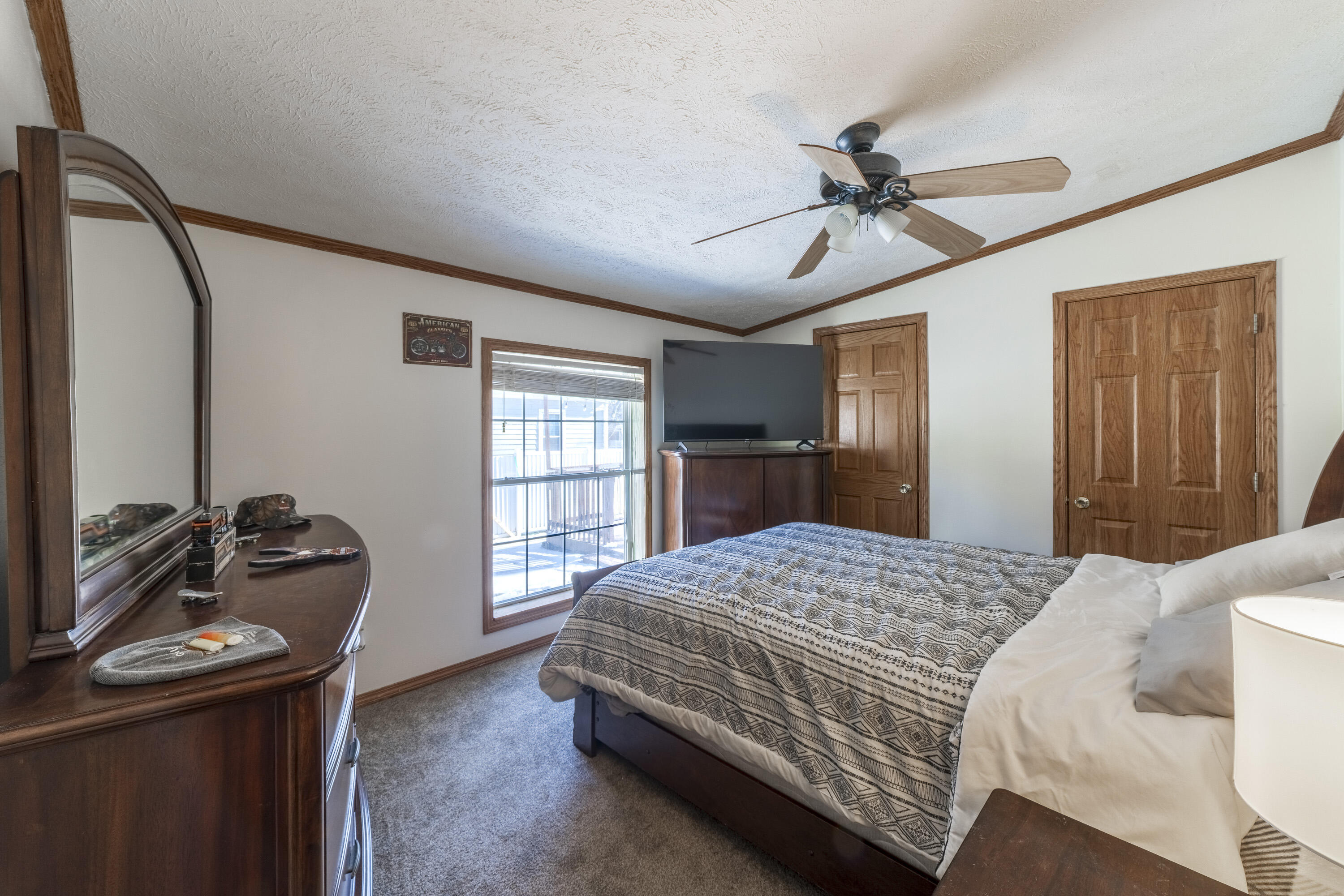 409 South Street Hebron, IN 46341 - Photo 29 of 36 a bedroom with a bed and a dresser with wooden floor