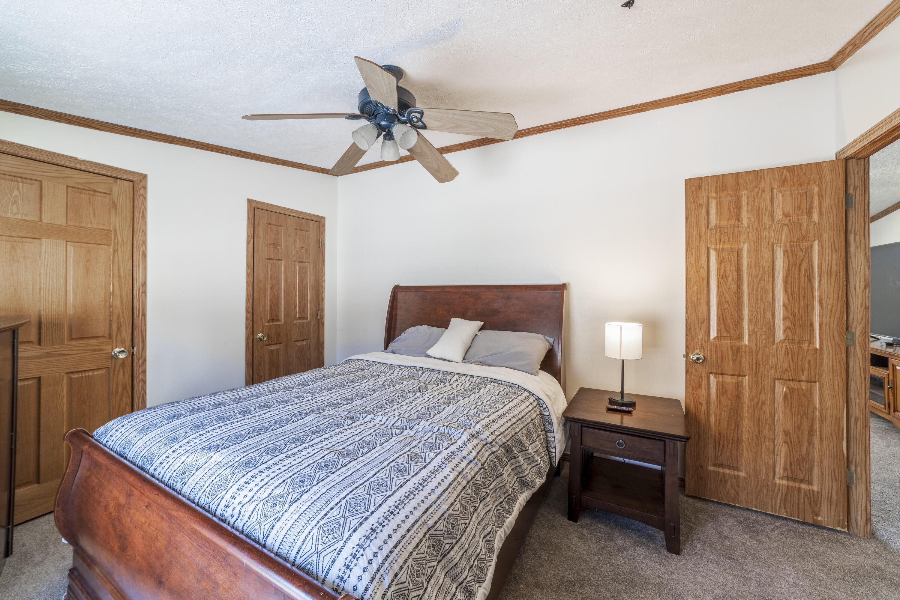 409 South Street Hebron, IN 46341 - Photo 30 of 36 a bedroom with a bed and a chandelier