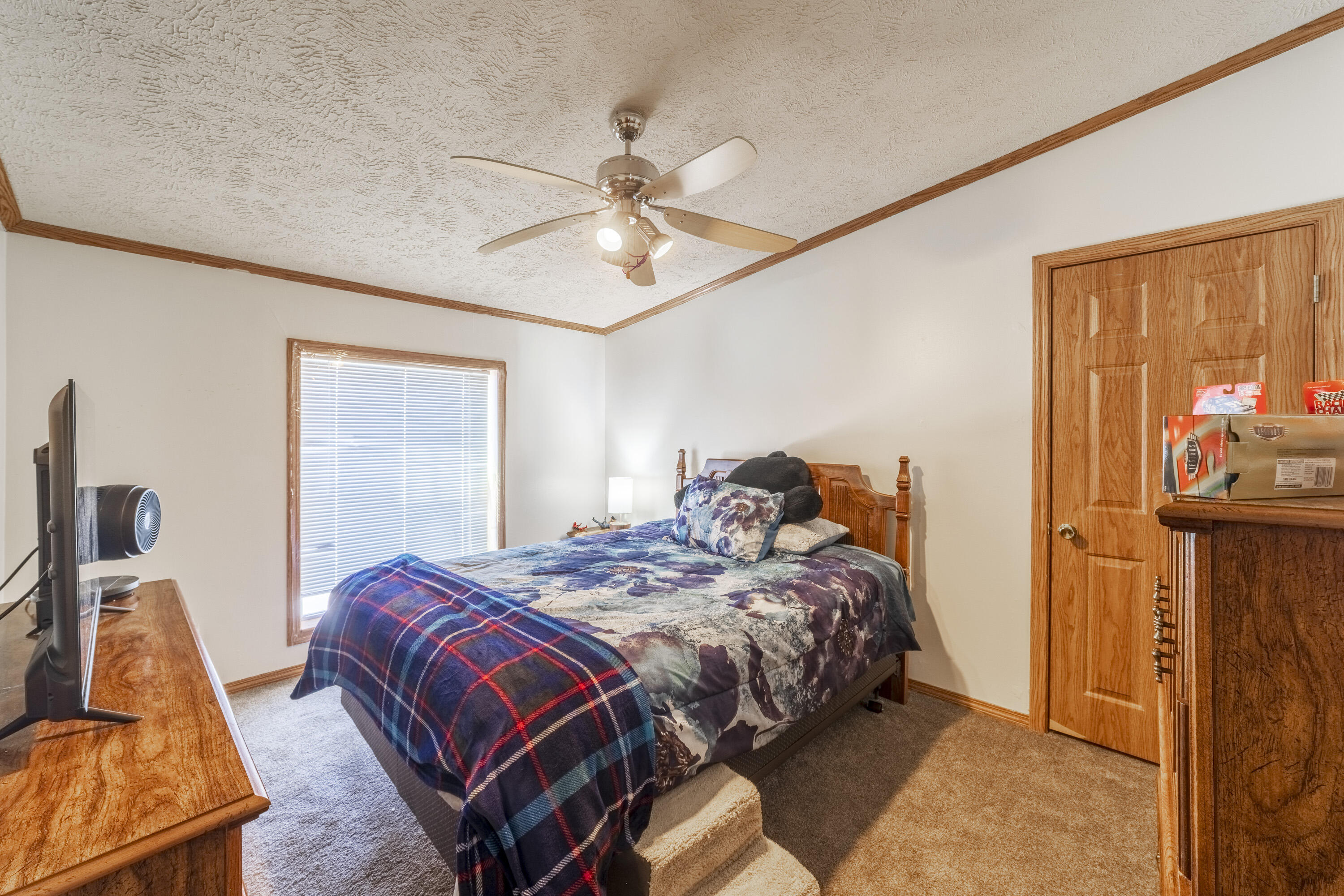 409 South Street Hebron, IN 46341 - Photo 32 of 36 a bedroom with a bed and a chandelier