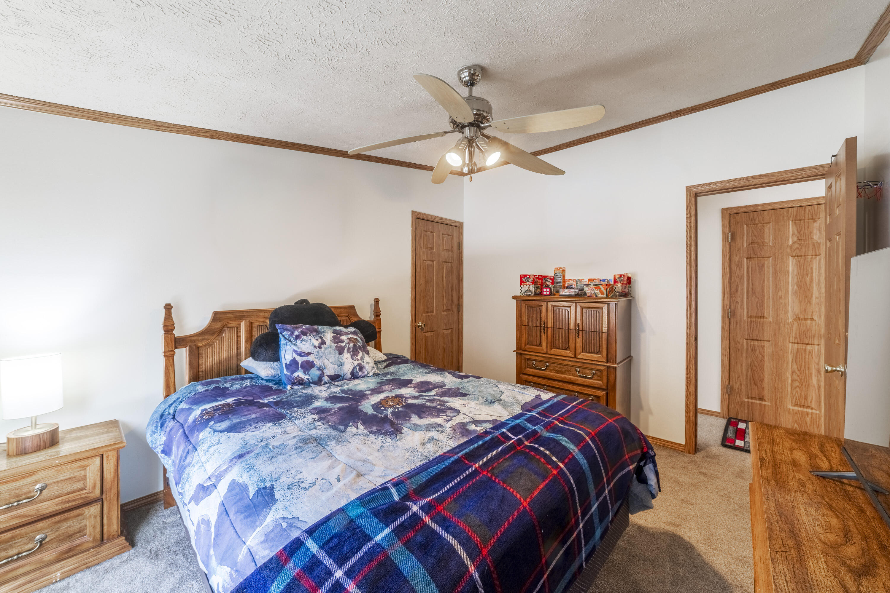 409 South Street Hebron, IN 46341 - Photo 34 of 36 a bedroom with a bed and a chandelier