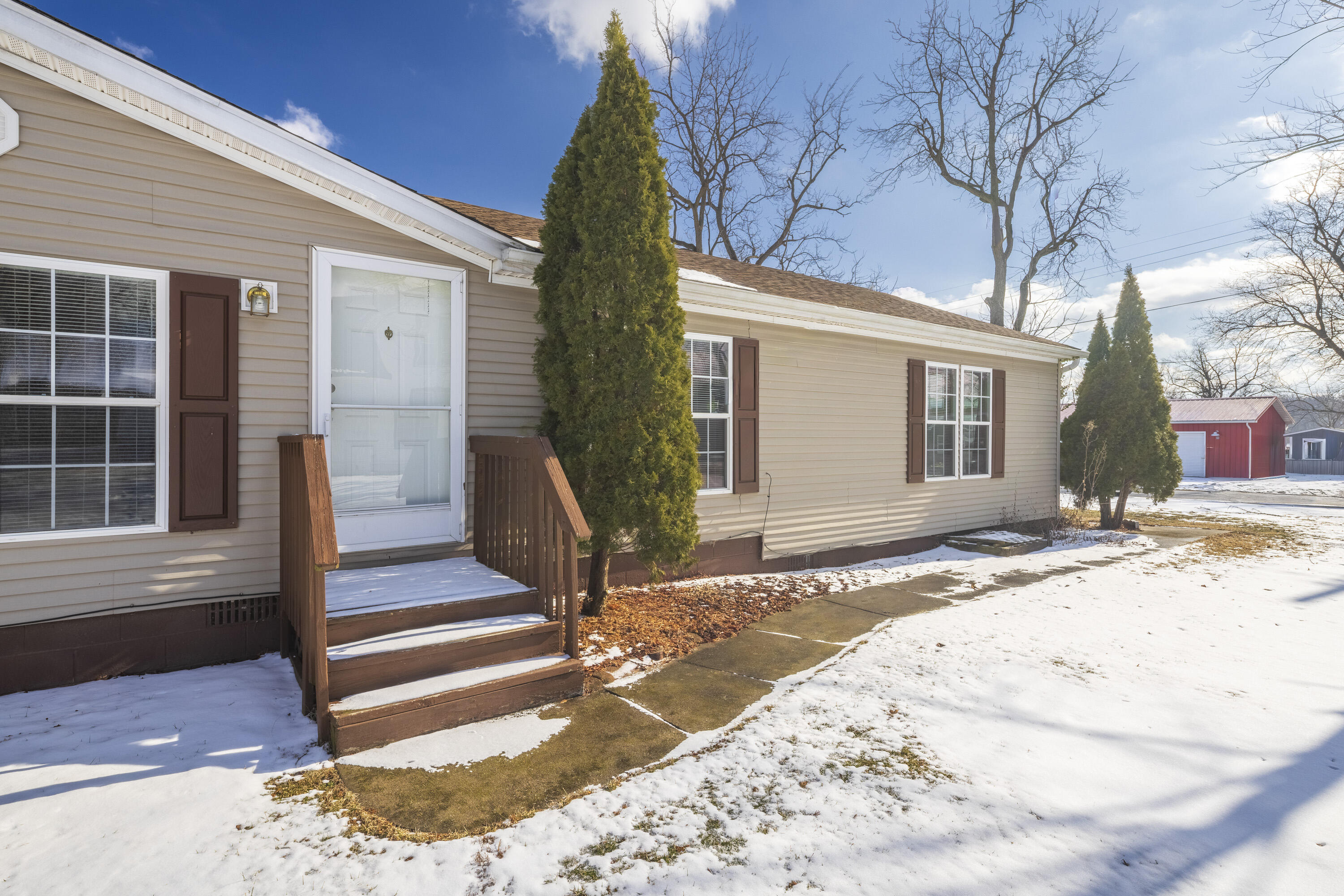 409 South Street Hebron, IN 46341 - Photo 8 of 36 a view of a house with snow on the side of the road