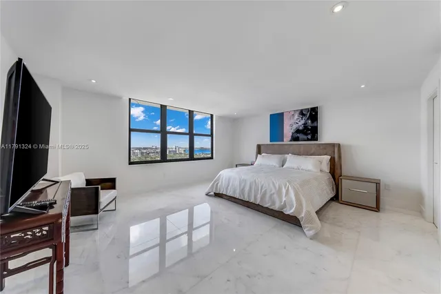 a bedroom with a bed and a flat screen tv