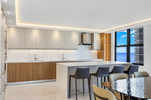 a kitchen with a table chairs and window