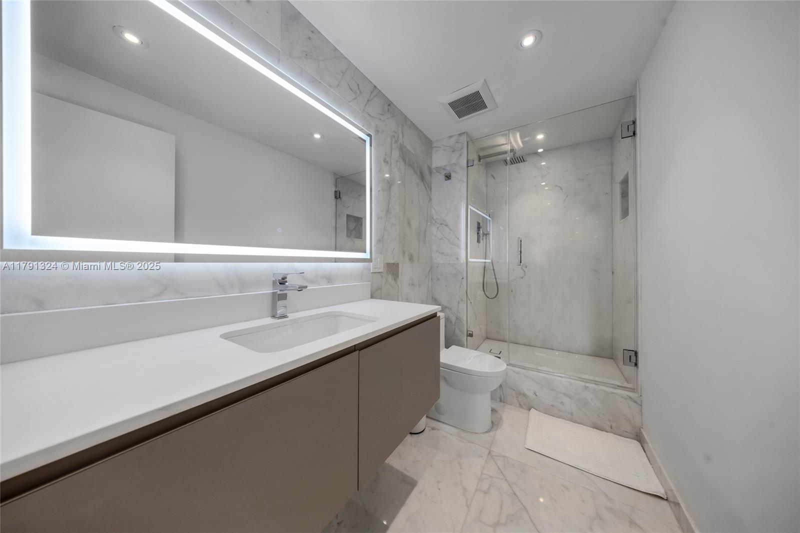 9801 Collins Avenue, Unit 17R Bal Harbour, FL 33154 - Photo 19 of 46 a bathroom with a sink a toilet and shower