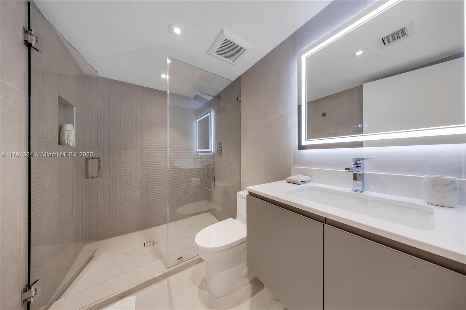 9801 Collins Avenue, Unit 17R Bal Harbour, FL 33154 - Photo 20 of 46 a bathroom with a sink a toilet and shower