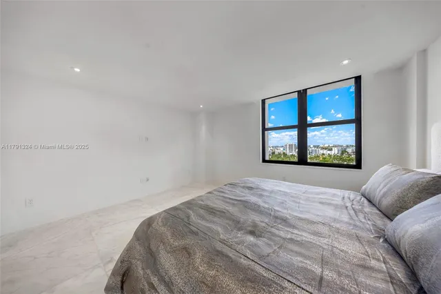 a bedroom with a large bed and a window