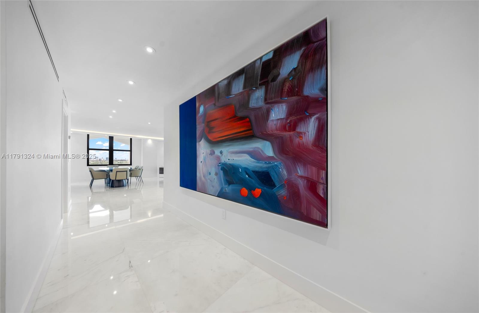 9801 Collins Avenue, Unit 17R Bal Harbour, FL 33154 - Photo 24 of 46 a view of a hallway with paintings on the wall