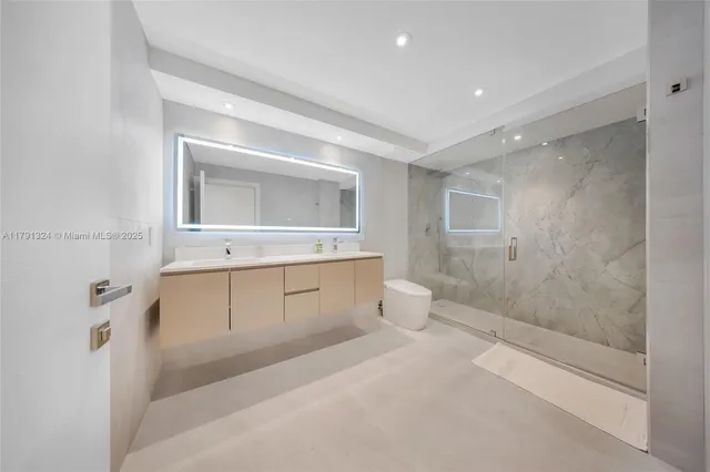 a spacious bathroom with a bathtub shower sink mirror and toilet