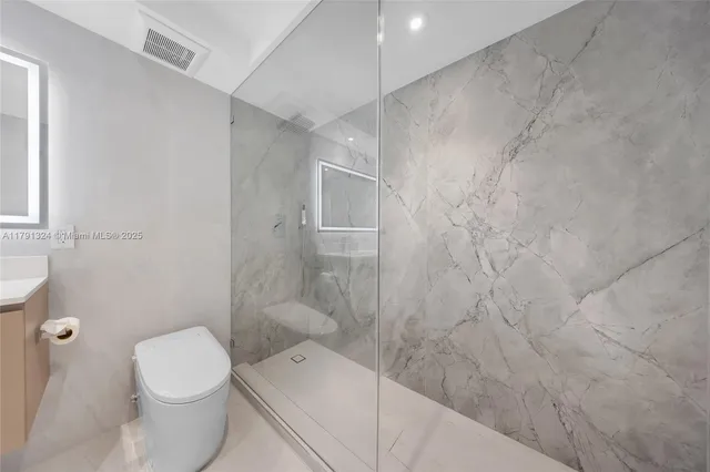 a bathroom with a toilet and a shower