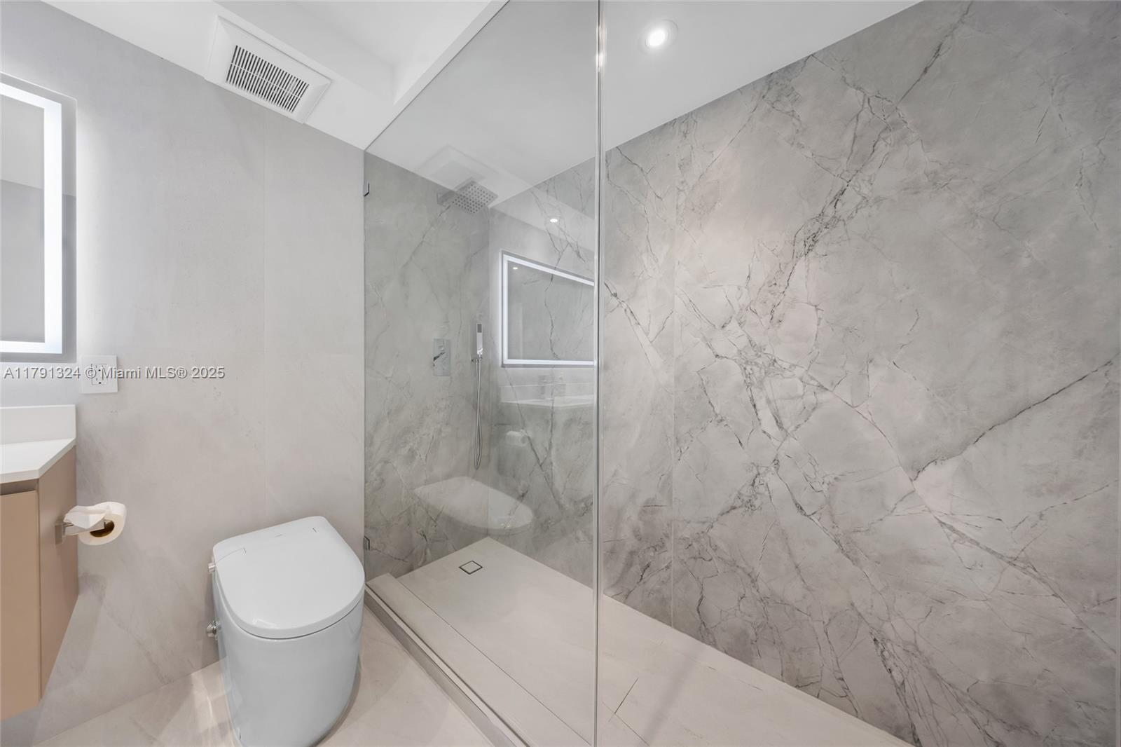 9801 Collins Avenue, Unit 17R Bal Harbour, FL 33154 - Photo 27 of 46 a bathroom with a toilet and a shower