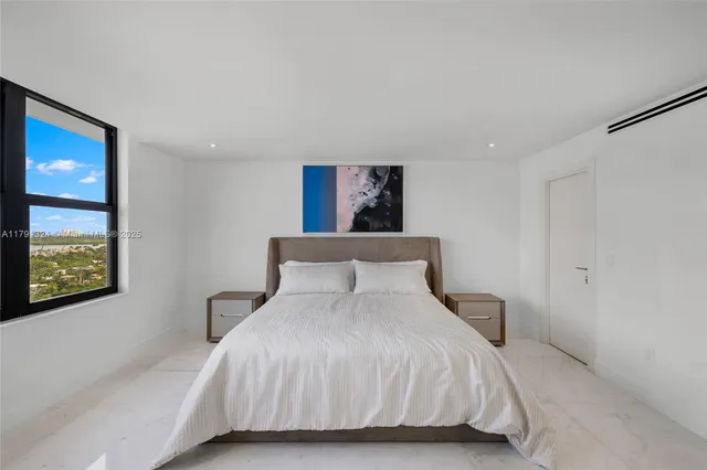 a bedroom with a bed and a night stand