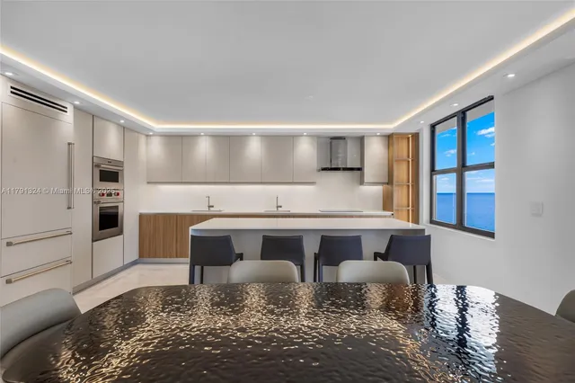 a view of kitchen with stainless steel appliances granite countertop a stove a sink and a refrigerator