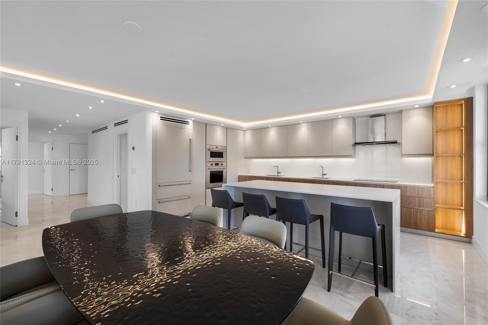 9801 Collins Avenue, Unit 17R Bal Harbour, FL 33154 - Photo 4 of 46 a living room with stainless steel appliances kitchen island granite countertop a sink and a refrigerator