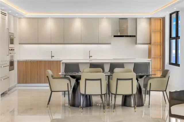 a kitchen with a table chairs cabinets and a window