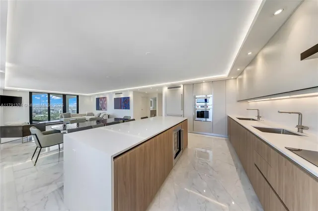 a kitchen with stainless steel appliances a sink stove and cabinets