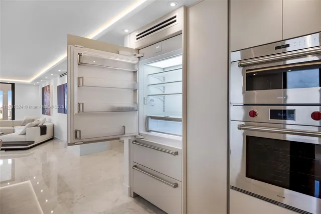 a kitchen with cabinets and stainless steel appliances