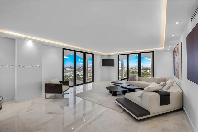 a living room with furniture and large windows