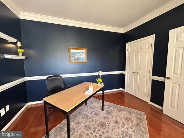 an empty room with windows and chandelier fan