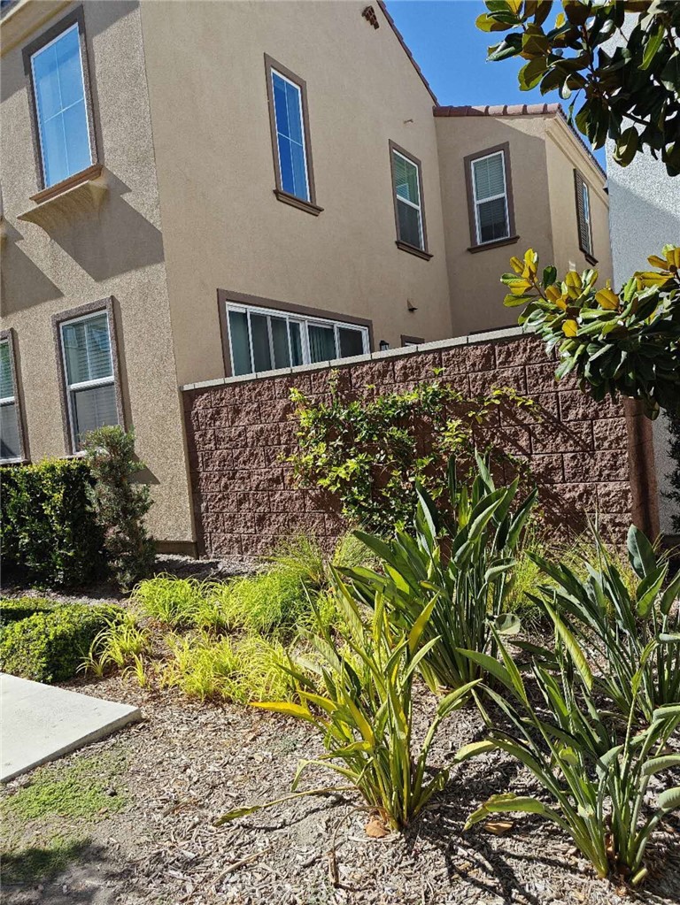 8787 Wanderlin Place Chino, CA 91708 - Photo 2 of 14 a front view of a house with a garden