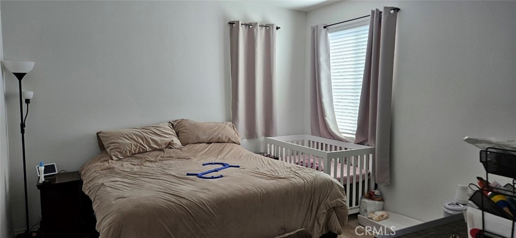 8787 Wanderlin Place Chino, CA 91708 - Photo 10 of 14 a bedroom with a bed and a window