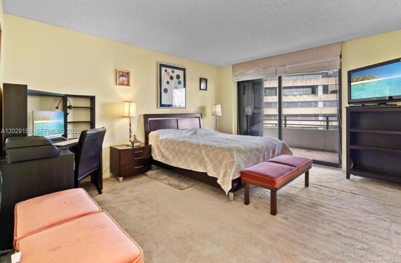 151 Southeast 15th Road, Unit 502 Miami, FL 33129 - Photo 11 of 31 a bedroom with a bed and wooden floor