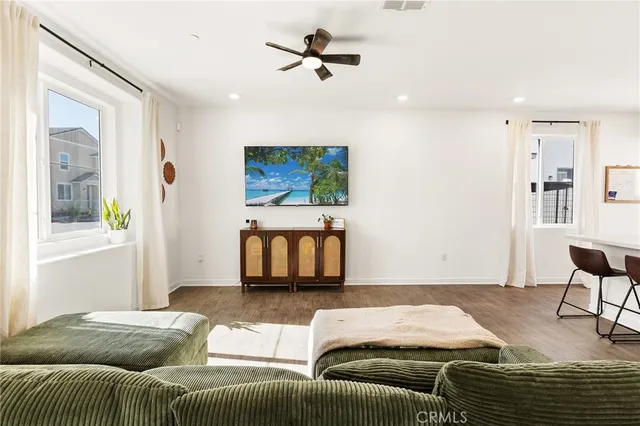 a kitchen with kitchen island granite countertop a sink cabinets and wooden floor