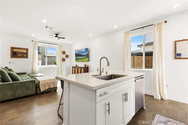 a kitchen with stainless steel appliances granite countertop a sink and cabinets