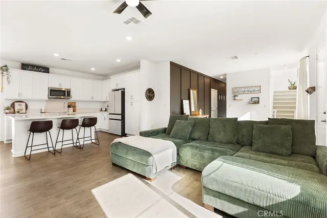 a living room with furniture and kitchen view