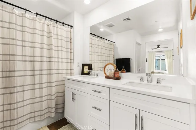 a bathroom with a double sink and a mirror