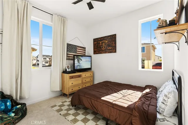 a bedroom with a bed and a television