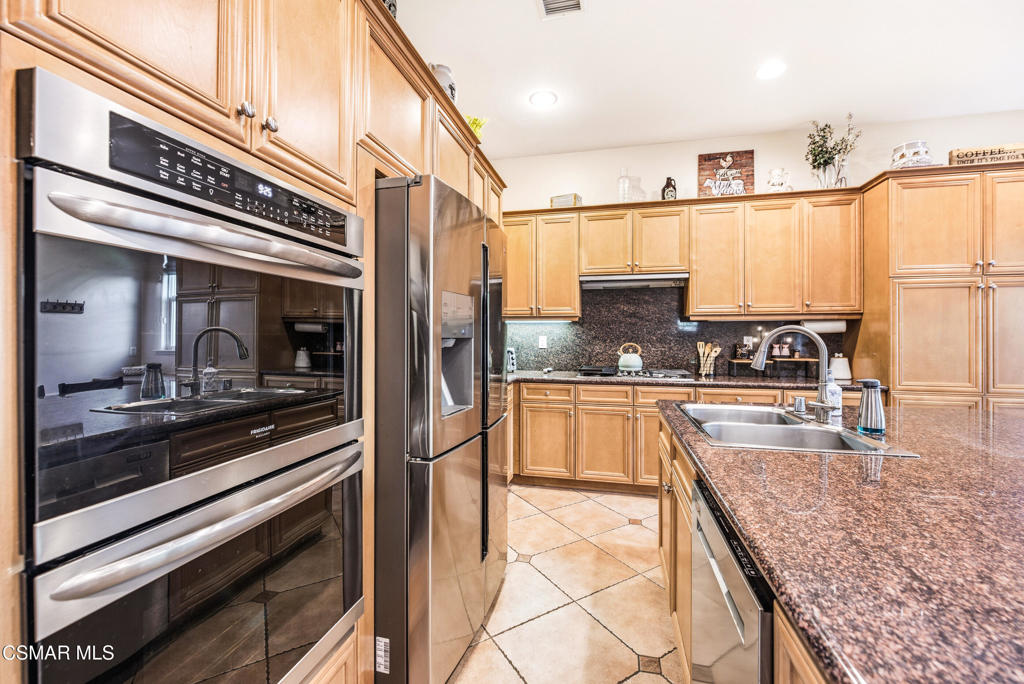 4741 Westwood Street Simi Valley, CA 93063 - Photo 12 of 50 a kitchen with stainless steel appliances granite countertop a sink and cabinets