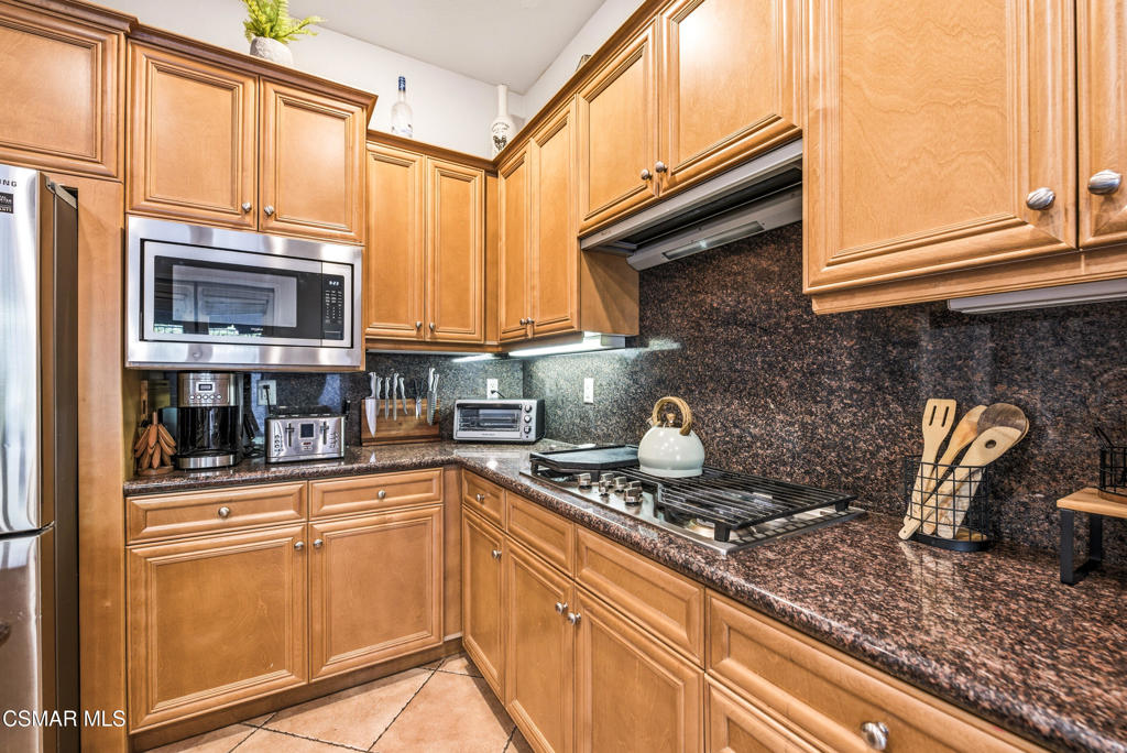 4741 Westwood Street Simi Valley, CA 93063 - Photo 13 of 50 a kitchen with stainless steel appliances granite countertop a sink a stove and cabinets