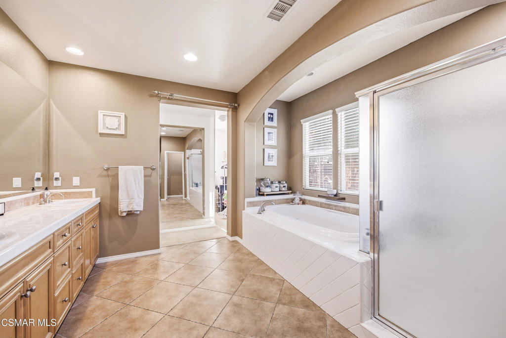4741 Westwood Street Simi Valley, CA 93063 - Photo 26 of 50 a large en suite bathroom with a tub sink and mirror