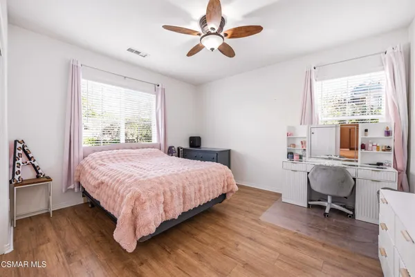 a bedroom with a bed a desk and chair