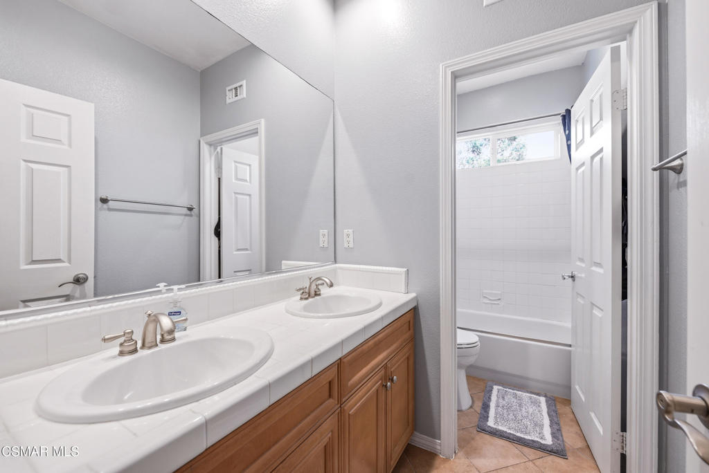 4741 Westwood Street Simi Valley, CA 93063 - Photo 32 of 50 a bathroom with 2 sink and a mirror