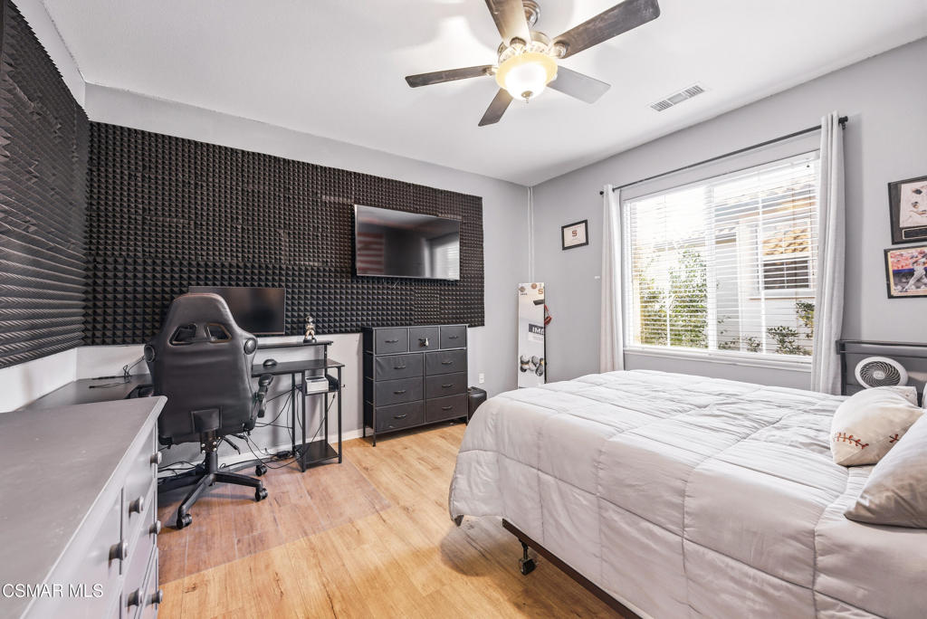 4741 Westwood Street Simi Valley, CA 93063 - Photo 34 of 50 a bedroom with a bed and a chair with the wooden floor