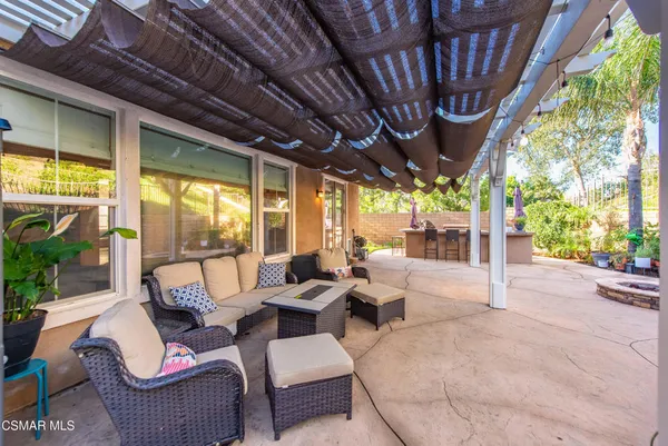 a outdoor space with patio couches and iron fence