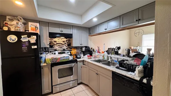 a kitchen with a stove and a refrigerator