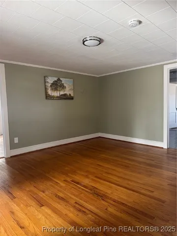 a view of a room with wooden floor