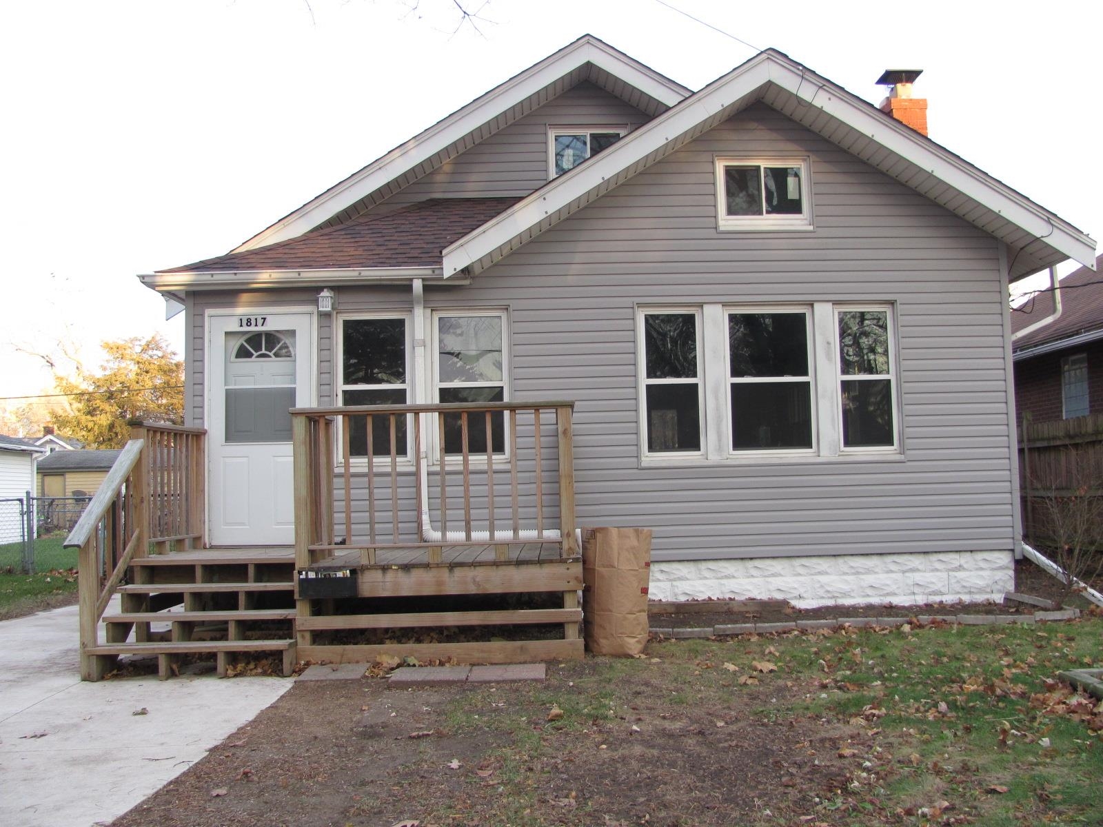 1817 Ridge Avenue Rockford, IL 61103 - Photo 1 of 48 a front view of a house with a yard