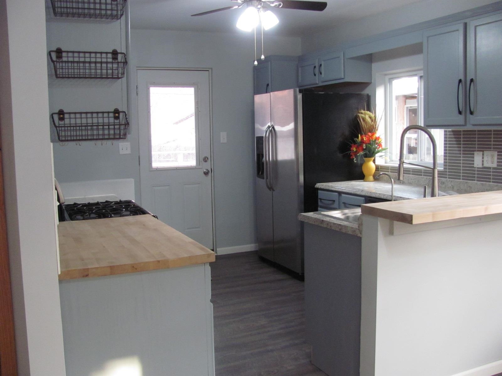 1817 Ridge Avenue Rockford, IL 61103 - Photo 7 of 48 a kitchen with a refrigerator and a sink
