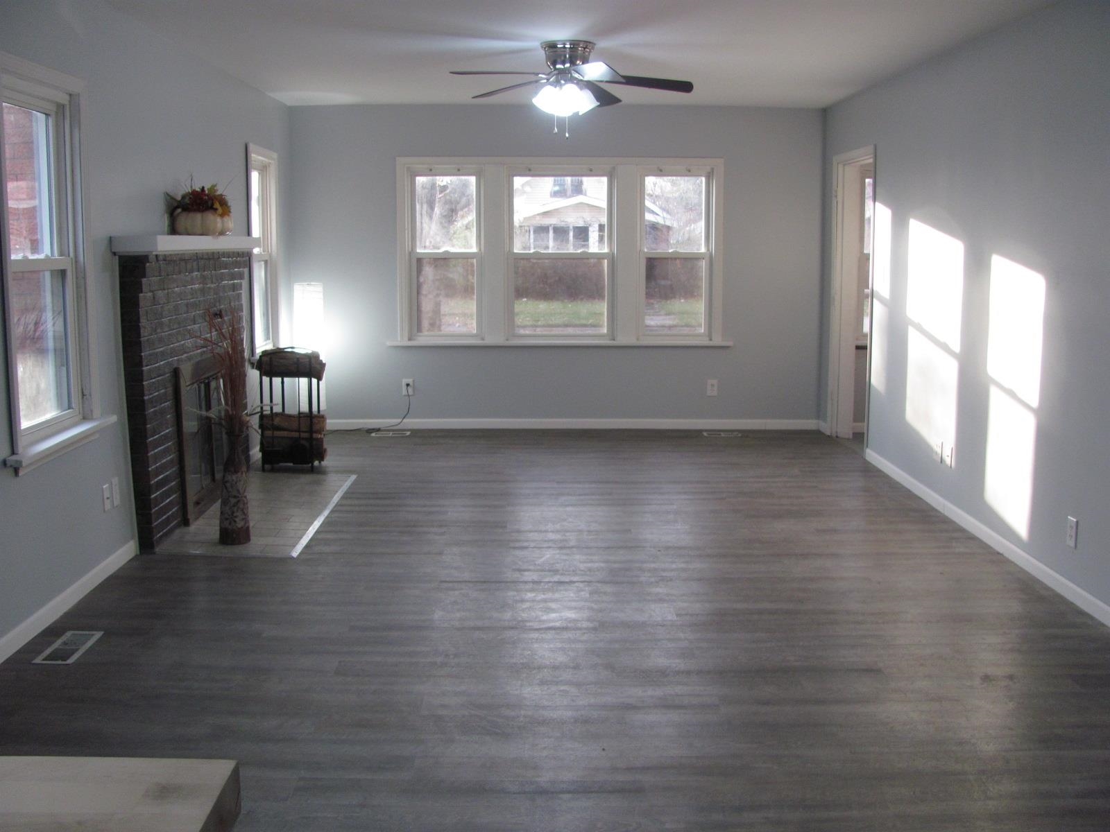 1817 Ridge Avenue Rockford, IL 61103 - Photo 8 of 48 a view of an empty room with wooden floor and a window
