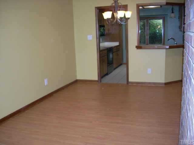 4339 Sunscape Lane Raleigh, NC 27613 - Photo 2 of 10 Dining room has new beautiful hardwood look laminate flooring as does living room and hall.