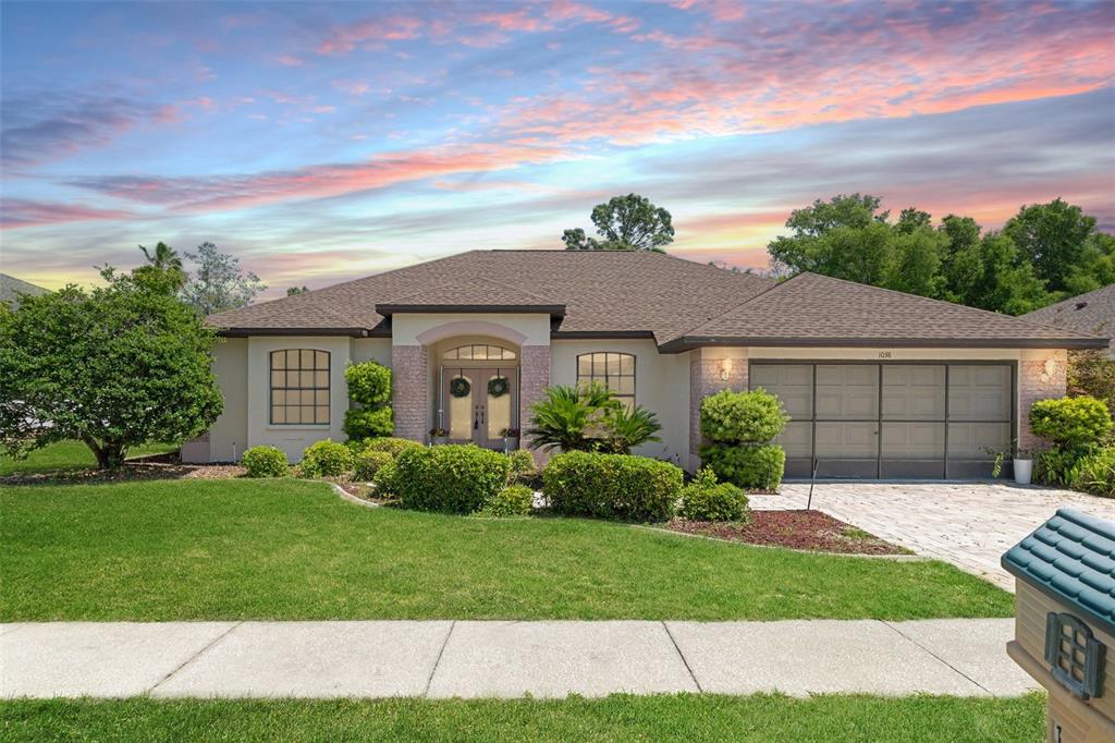 1038 Greenturf Road Spring Hill, FL 34608 - Photo 1 of 1 a front view of a house with a garden