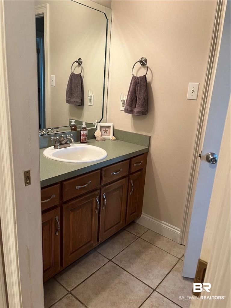 16311 Old Brady Road Bay Minette, AL 36507 - Photo 32 of 38 Bathroom vanity with a white undermount sink, a light green countertop, and a large wall-mounted mirror